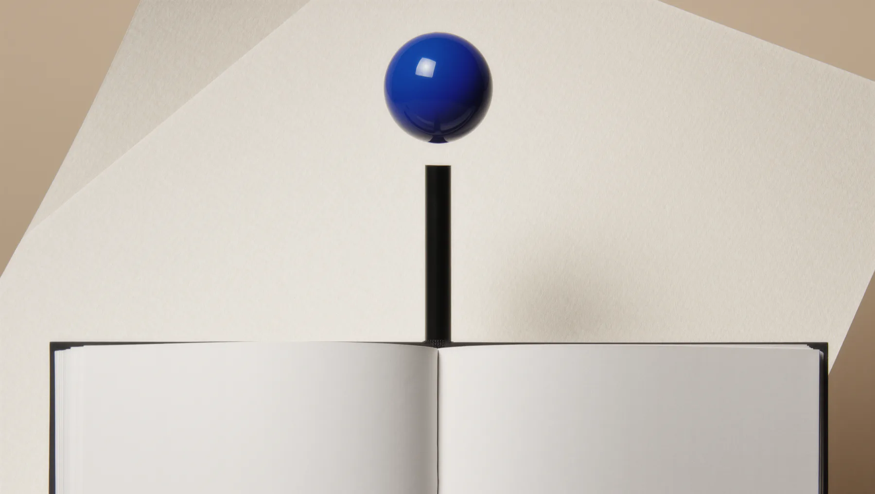 Open notebook with blank pages, a black rod and a floating cobalt-blue sphere behind it